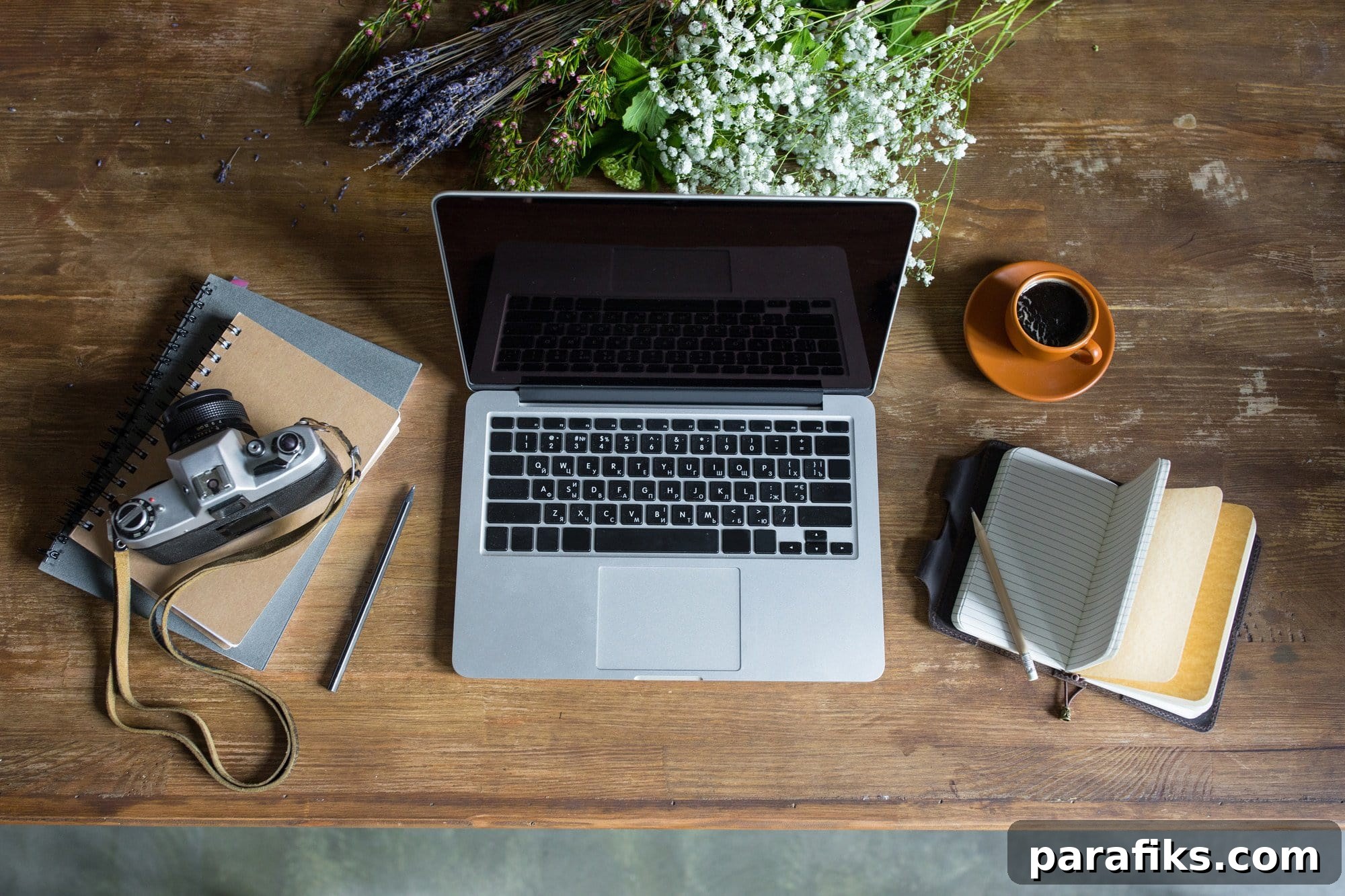 14 Places to Find Freelance Writing Jobs (Start With No Experience) 2 top view of laptop, diaries, vintage photo camera and cup of coffee on wooden tabletop- freelance writing jobs