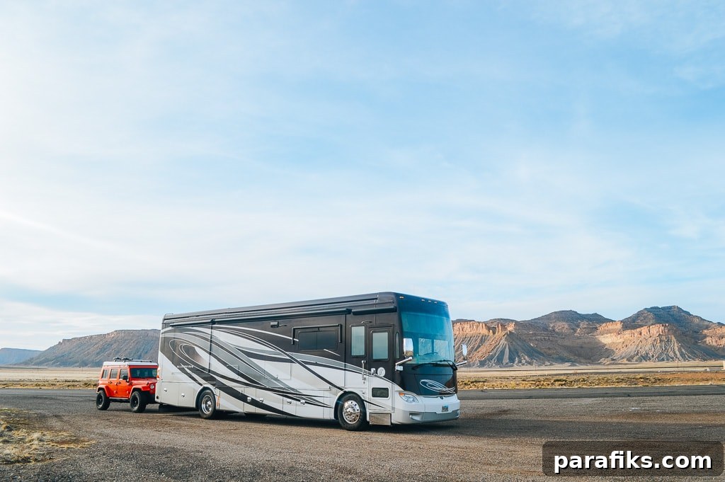 18 Real Ways to Get Paid to Travel the World 3 Campground host - RV towing a red Jeep