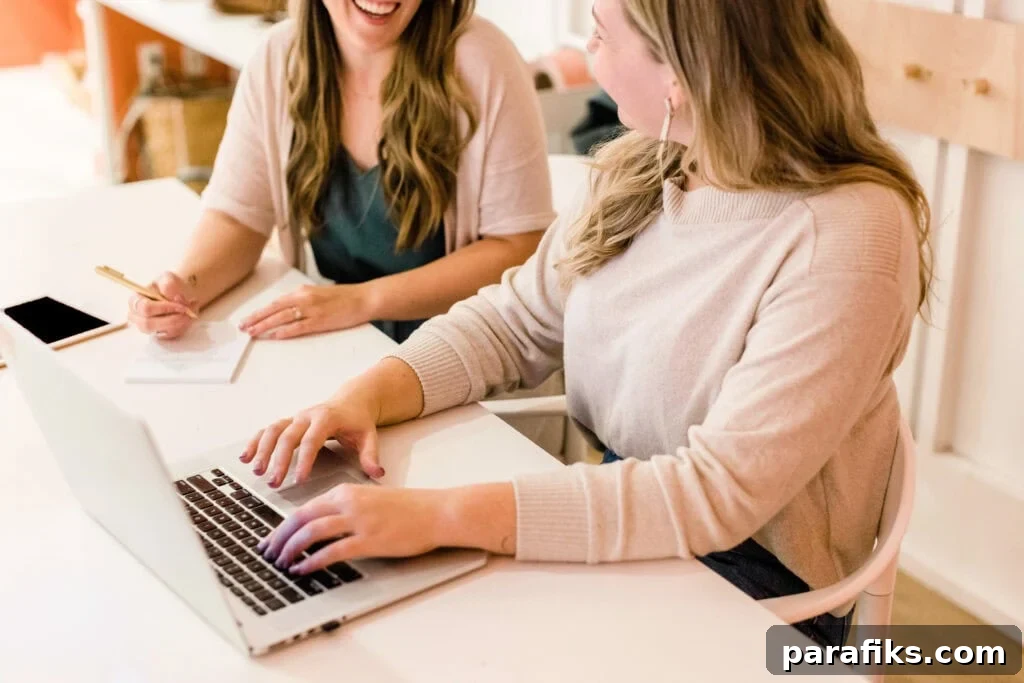 How to Earn $6,000 a Month: 15 Proven Income Ideas 2 Two people sitting next to each other talking at a desk for an article about how to make $6,000 a month
