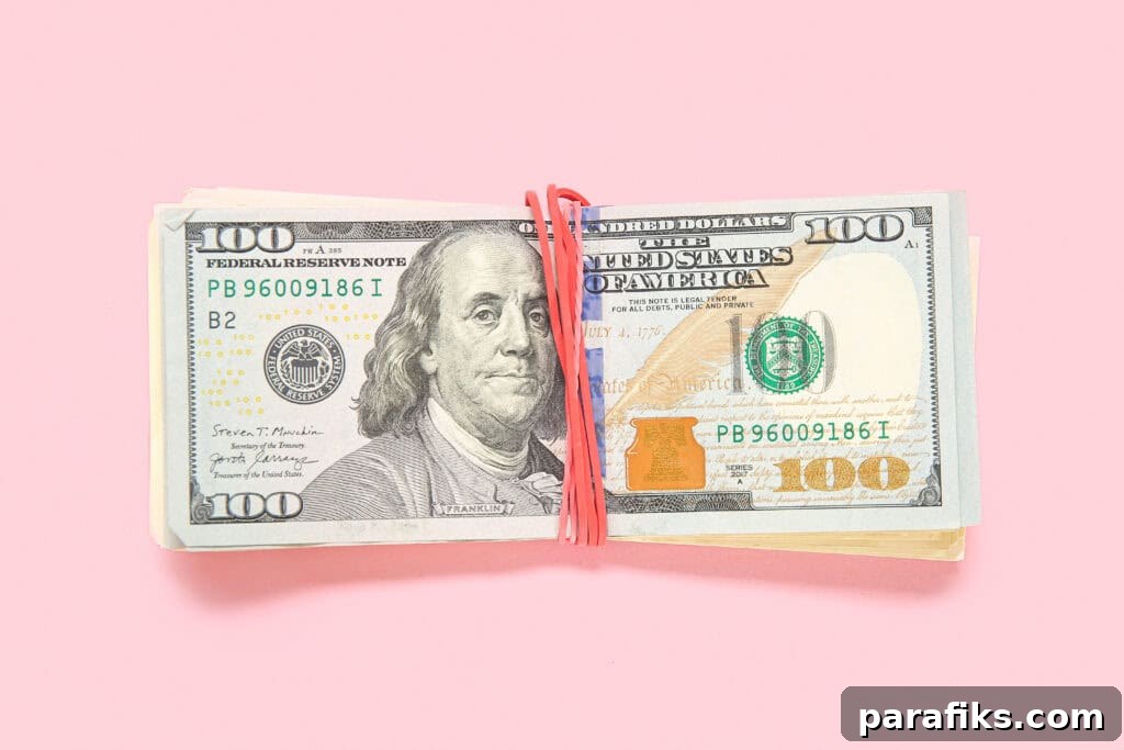 7 Ways to Earn Extra Income After a Long Workday 2 bundle of money and $100 bill on top for article ways to make more money when you're tired at the end of the day