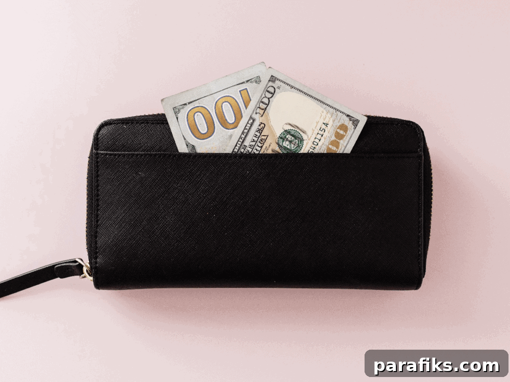 Declutter Your Home Fast and Earn $500 This Weekend 2 $100 bill in black wallet for the article How To Quickly Declutter Your Home and Make $500 This Weekend