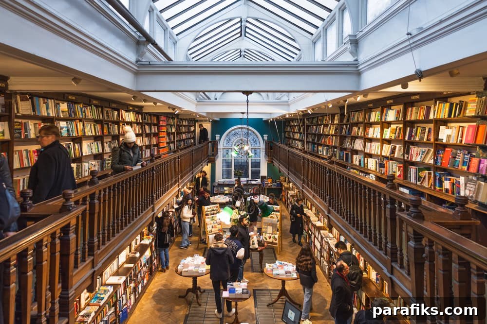 17 Lucrative Side Gigs for Avid Book Lovers 3 bookstore interior showcasing wooden shelves, skylight, and customers browsing books.