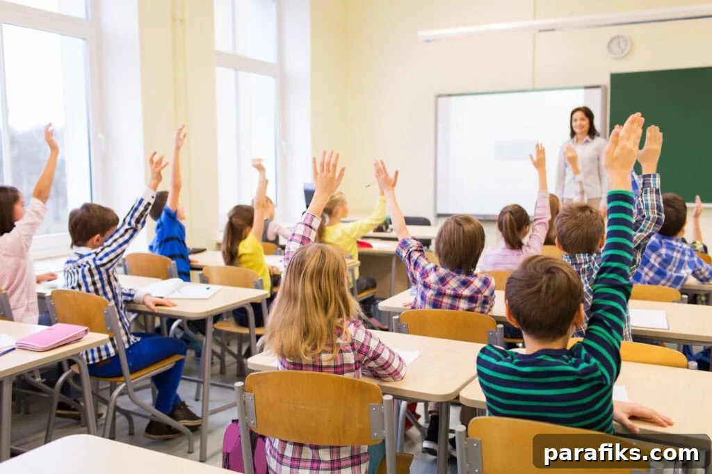 24 Jobs AI Won’t Replace That Still Need Human Skills 3 education, elementary school, learning and people concept - group of school kids with teacher sitting in classroom and raising hands