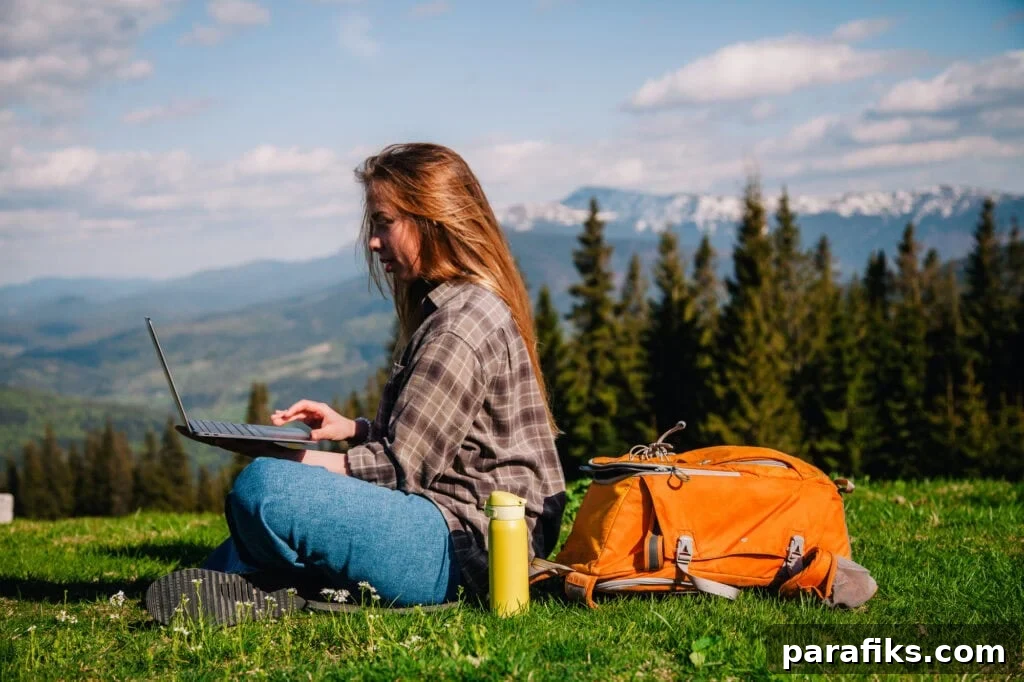 woman working on laptop while hiking