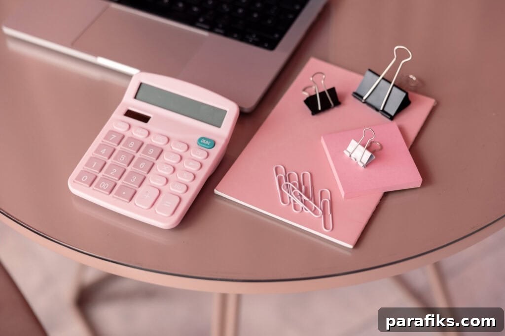 pink calculator and notebook on table